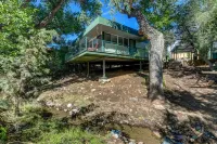 Modern cabin hidden among the trees-- Unwind and relax on the porch creek-side.