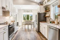 Modern cottage with covered deck, grill & fireplace - walk to beach/bars/dining Hotels near Marsh's Free Museum