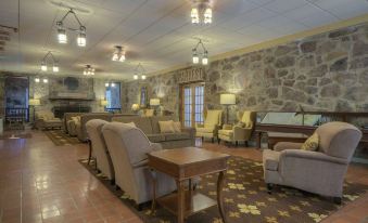 a cozy living room with various furniture , including a couch , chairs , and a dining table at Mountain Lake Lodge