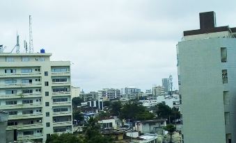 a city skyline with tall buildings and a cloudy sky , taken from a high vantage point at Residence Maryka II