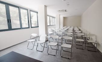 a room filled with rows of white chairs arranged in a semicircle , possibly for a meeting or presentation at Golden View