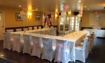 a dining room set up for a party , with tables and chairs arranged in a circle at The Pheasant Inn