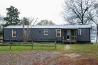 Lake front retreat, covered boat dock, large deck , fenced play area, RV parking