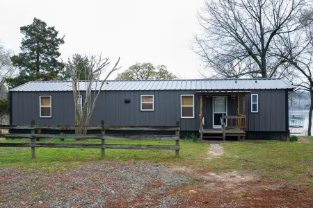 Lake front retreat, covered boat dock, large deck , fenced play area, RV parking