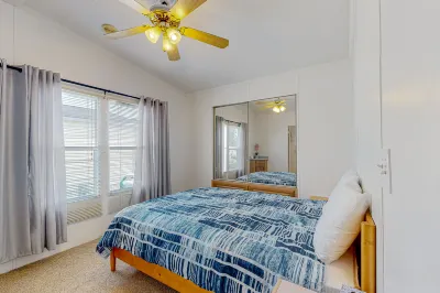Sunny coastal home with private patio, on-site pool, central AC, & W/D