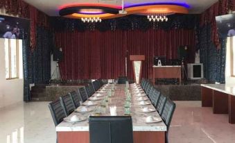 a long dining table set up for a formal event , with several chairs arranged around it at Infinity See Sun Resort