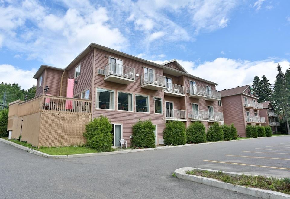 a row of apartment buildings with balconies and greenery on the side , situated next to each other at Hotel le Versailles