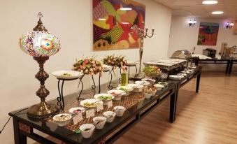 There is a variety of tables of different types and sizes at the buffet in this hotel at Desert Sounds - Boutique Hotel
