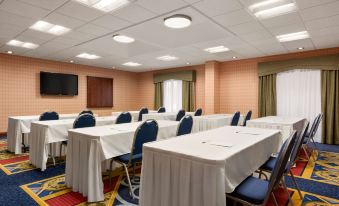 a conference room with blue chairs and white tables is set up for a meeting at Hampton Inn Warrenton, VA