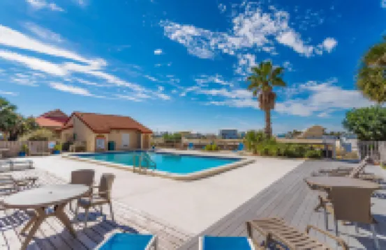 Sound-view beach condo with private balcony, pool, grills, central AC, & W/D