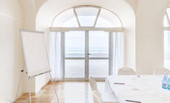 a conference room with a large table , chairs , and a whiteboard set up for a meeting at Precise Resort Tenerife