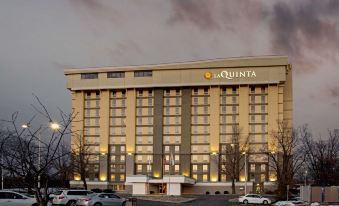 "a large hotel building with a sign that reads "" la quinta "" prominently displayed on the front" at La Quinta Inn & Suites by Wyndham Springfield MA