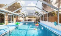 Home with play room, enclosed pool and hot tub. Only 10 minutes from the beach!