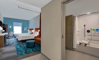 a hotel room with two beds , one on the left side and the other on the right side of the room at Home2 Suites by Hilton Richmond Hill Savannah I 95