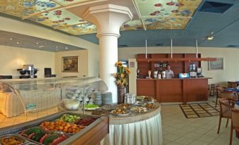 a well - equipped hotel kitchen with a dining area and a buffet - style dining area , where guests can enjoy a variety of food options at Park Hotel Bellevue