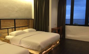 a modern bedroom with wooden furniture , white bedding , and a window offering a view of the sea at The Oikos Hotel