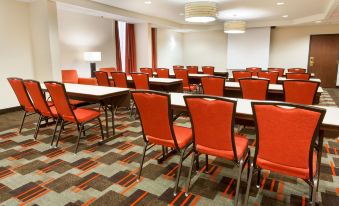a conference room with rows of chairs arranged in a semicircle , ready for a meeting or presentation at Drury Inn & Suites St. Louis Airport