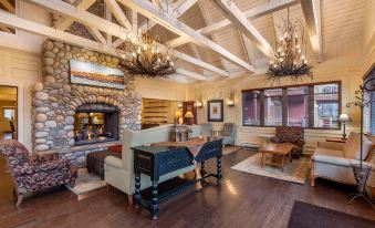 a spacious living room with a fireplace and a fireplace mantle , surrounded by wooden furniture at Hilton Grand Vacations Club Blue Mountain Canada