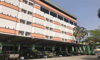 a parking garage with multiple cars parked , some of which are in the foreground and others in the background at Lopburi Residence Hotel