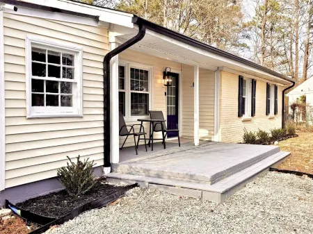 Updated 4-bedroom house with relaxing sunroom; minutes from downtown Raleigh.