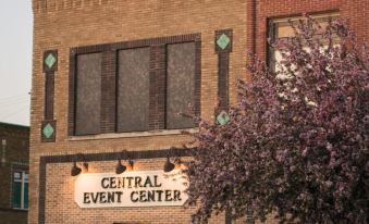 the central event center is a historic brick building with a sign above the entrance at Inn on Central