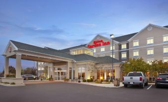 "a large hotel with a red sign that says "" hilton garden inn "" is shown at dusk" at Hilton Garden Inn Merrillville