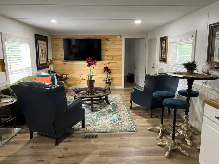 Completely renovated mobile home sitting own a pond.