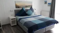 Bright, spacious comfort apartment with private garden and walk-in shower.