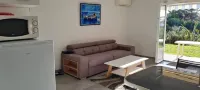 Ground-floor apartment with garden and barbecue near beach and shops.