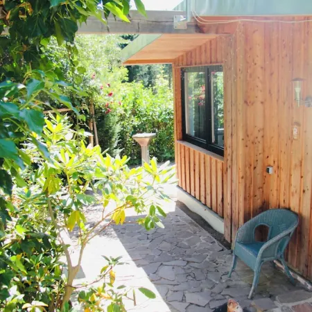 Modernly Furnished Bungalow with Fireplace, Surrounded by Greenery.