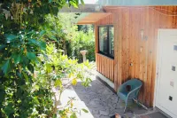 Modernly Furnished Bungalow with Fireplace, Surrounded by Greenery.