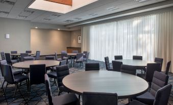 a large conference room with round tables and chairs arranged in rows , providing seating for attendees at Courtyard Baltimore Hunt Valley