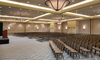 a large conference room with rows of chairs arranged in a semicircle , ready for an event at Hilton Melbourne, FL