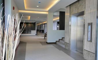 a modern office building with an elevator and staircase , providing a comfortable and functional atmosphere at The Mangrove Hotel