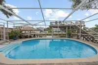 Cozy Canal Escape! Screen Covered Pool, Sunroom, Sun Deck, & Floating Boat Dock - 4-Star