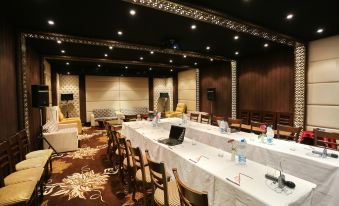 a conference room set up for a meeting , with several chairs arranged in a semicircle around a table at Hotel CH2