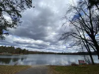 Cozi retreat set in the woods within walking distance of Waubee Lake.