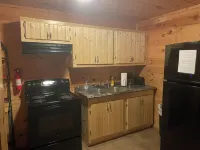 3BR, 1 Bath Cabin with hot tub, full kitchen, and living room.