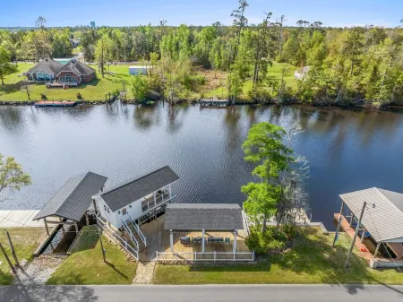 Luxury riverfront home w/ pool, fishing dock, & boat house w/ lift ! Sleeps 14