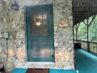 Spacious suite surrounded by nature with living room, fireplace, porch, fire pit