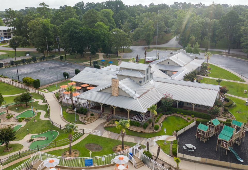a large resort - style building with a playground and greenery in the background , creating a serene environment at Holiday Inn Club Vacations Villages Resort Lake Palestine
