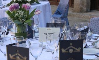 a dining table set for a formal event , with wine glasses and place settings arranged neatly at Parador de Zamora