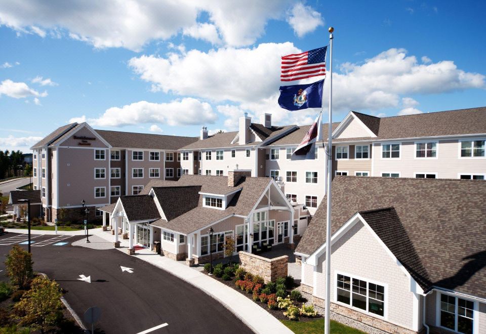 "a large building with a flag on top of it and the words "" stonehenge "" written in cursive" at Residence Inn Auburn