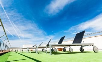 a row of solar panels on the roof of a building with a clear blue sky in the background at Artiem Capri
