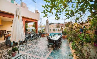 an outdoor dining area with a table and chairs set up for a group of people to enjoy a meal at Grand Hotel Madaba