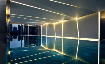 The interior design includes a large reflective floor and illuminated walls at EAST Beijing