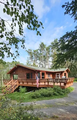 Home nestled in a private forest setting,  mountain views, walk to Kenai Lake.