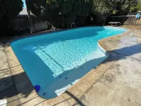 Beautiful Home in quiet neighborhood with a pool and close to stores & highways.
