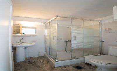 a modern bathroom with a walk - in shower , toilet , and sink , all in a clean and well - maintained manner at Hotel Summery