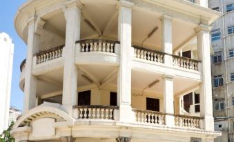 A large white building with balconies on the side and an ornate stone facade at Dorsett Mongkok Hong Kong